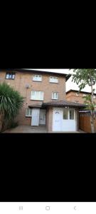 a large brick building with two white garage doors at Budget Studio Room Thamesmead in Thamesmead