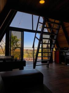 a room with a large window with a view of the ocean at Cabanas do Cerrado Brasil in Novo Gama +11 photos