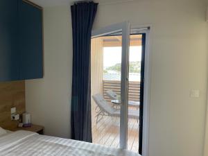 a bedroom with a sliding glass door to a balcony at Sea House in Drage