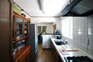 a small kitchen with a sink and a stove at Echo Villa the Spacious in Hakuba
