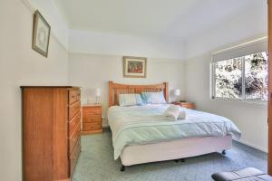 a bedroom with a bed and a dresser and a window at Apsley Cottage Hosted by Halls Gap Accommodation in Halls Gap
