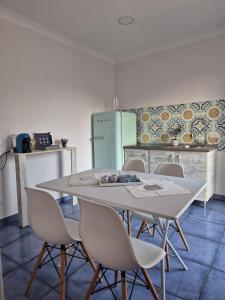 a kitchen with a table and chairs and a refrigerator at Residenza Calypso in Pizzo