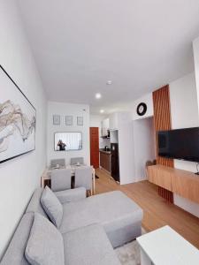 a living room with a couch and a table at Cozy 2BR Condo near Airport- Perfect for travelers in Lapu Lapu City