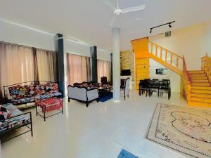 a living room with couches and a dining room at Luxor in Al Karnak