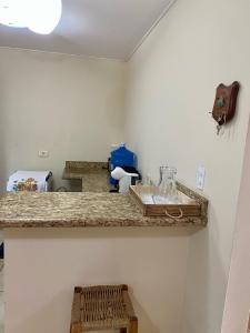 a kitchen with a counter with a counter top at Casa em Bonito in Bonito