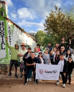 a group of people posing for a picture with a sign at Hostal Bella Esperanza in Humahuaca +5 photos