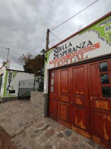 a building with red doors and a sign on it at Hostal Bella Esperanza in Humahuaca