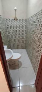 a bathroom with a toilet and a sink at POUSADA DOS REIS in Salinópolis +15 photos