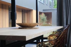 a wooden table with a bowl on top of it at Haehaenui Retreat - with Stoked hot tub in Arrowtown