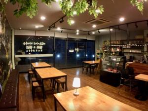 a restaurant with tables and chairs and a bar at Paju Bejoani in Paju
