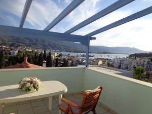 a balcony with a table and chairs and a view at KTM Sunny Villas in Poros