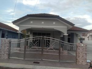 a house with a gate in front of it at Homestay Sinar in Jitra