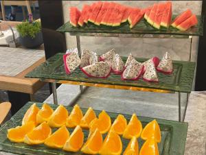 a bunch of oranges and watermelons on a shelf at Paco Hotel Guangzhou Baiyun Airport Liantang Metro in Huadu