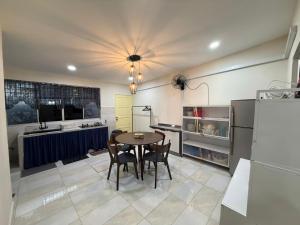a kitchen with a table and chairs in a room at Naura Homestay Batu Caves in Batu Caves