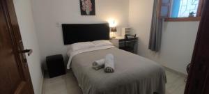 a bedroom with a bed with towels on it at Casa Azul em Santa Tereza in Belo Horizonte +11 photos