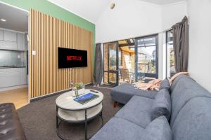 a living room with a couch and a tv at Great Short-Mid Term Stay! River Views & Games Room in Hamilton