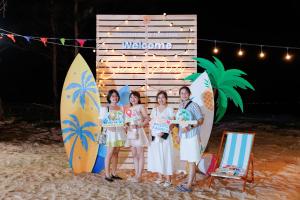 a group of people standing on the beach with surfboards at SummerSea Camping in Kon Rung (1)