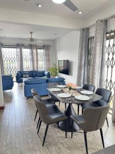 a living room with a table and chairs and a couch at Villa Azur in Grand Baie