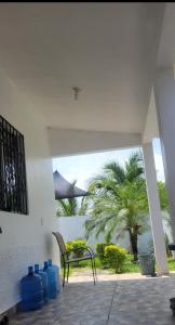 a patio with a bench and a palm tree at CASA con 2 habitaciones, Cocina,comedor y baño privados in Candelaria