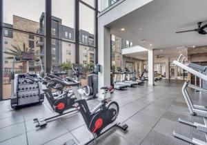 a gym with treadmills and cardio equipment in a building at The Link & Lounge, Close to Everything in Addison