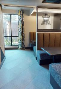 a waiting room with blue tile on the floor at The Link & Lounge, Close to Everything in Addison +20 photos