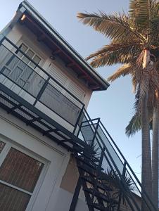una casa con un balcone e una palma di Mi Departamentito a Federación