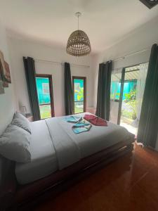 a bedroom with a large bed and a chandelier at Tropical Paradise Leelawadee Resort in Ko Chang +93 photos