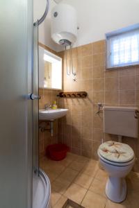 a bathroom with a toilet and a sink at Starigrad Apartment in Starigrad
