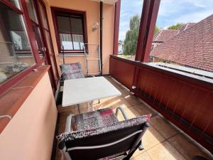 a balcony with a table and chairs and a table at BodenSEE Apartment Kressbronn Fischerdorf SEE 4 in Kressbronn am Bodensee
