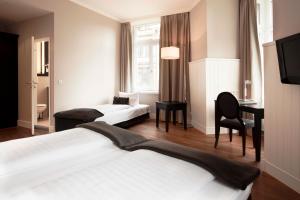 Cama ou camas em um quarto em Hotel Victoria