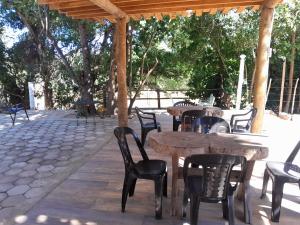 a patio with tables and chairs under a pavilion at Rancho de Pesca e Pousada Solar in Aquidavana