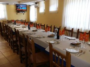 a conference room with a long table with plates and glasses at Hospedería Prepirineo in Undués-Pintano