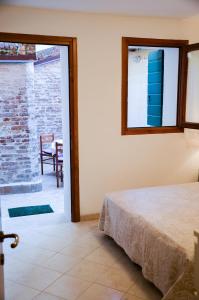 a bedroom with a bed and a window and a table at Cà Marin in Venice
