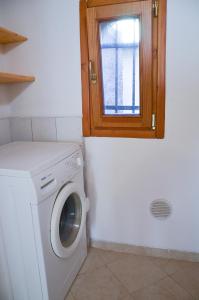 a laundry room with a washing machine and a window at Cà Marin in Venice