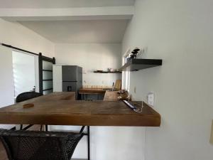 a kitchen with a wooden counter top on the wall at Bay Front Eco-Cottage in Corozal