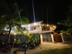 a house at night with lights in front of it at Journeyy INN in General Luna