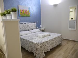 a small bedroom with a bed with a table at Welcome Holiday House in Polignano a Mare