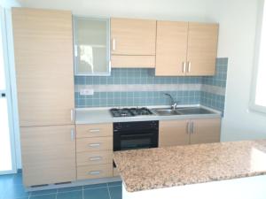 a kitchen with wooden cabinets and a sink at Archiammare Sea in San Lorenzo