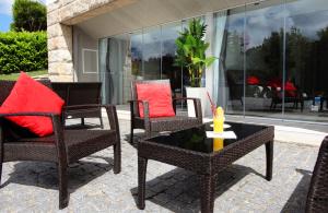 a patio with chairs and a table with a candle at Equinaturi in Santo Tirso