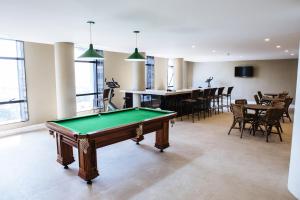 a room with a pool table and a dining room at Diamond Hotel in Rio de Janeiro
