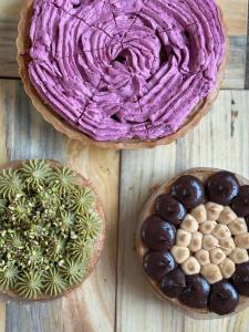 two pies with purple frosting on a wooden table at Mahendra Prakash in Udaipur