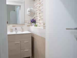 a bathroom with a sink and a mirror at Welcome Holiday House in Polignano a Mare