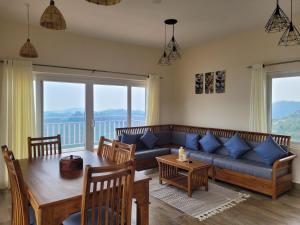 a living room with a couch and a table at The Ark Haven Ooty in Kolakambe +129 photos