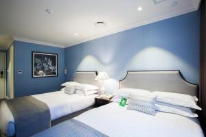 Ein Bett oder Betten in einem Zimmer der Unterkunft The Grand Hotel Myeongdong