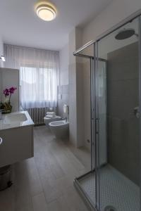 a bathroom with a shower and a sink and a toilet at St. Vitale’s Basilic view elegant apartment in Ravenna +32 photos