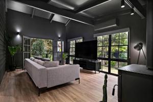 a living room with a couch and a flat screen tv at Eune House in Broke