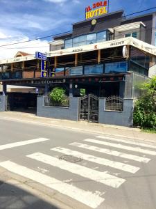 a building with a crosswalk in front of a street at Hotel IL Sole in Berane