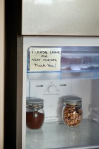 a refrigerator with two jars of food in it at Great Ocean Road Sunrises in Lorne