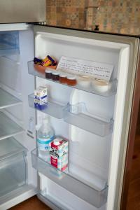 an open refrigerator filled with food and milk at Great Ocean Road Sunrises in Lorne