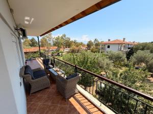 a balcony with chairs and a view of the desert at Andromachi's House in Pefkochori